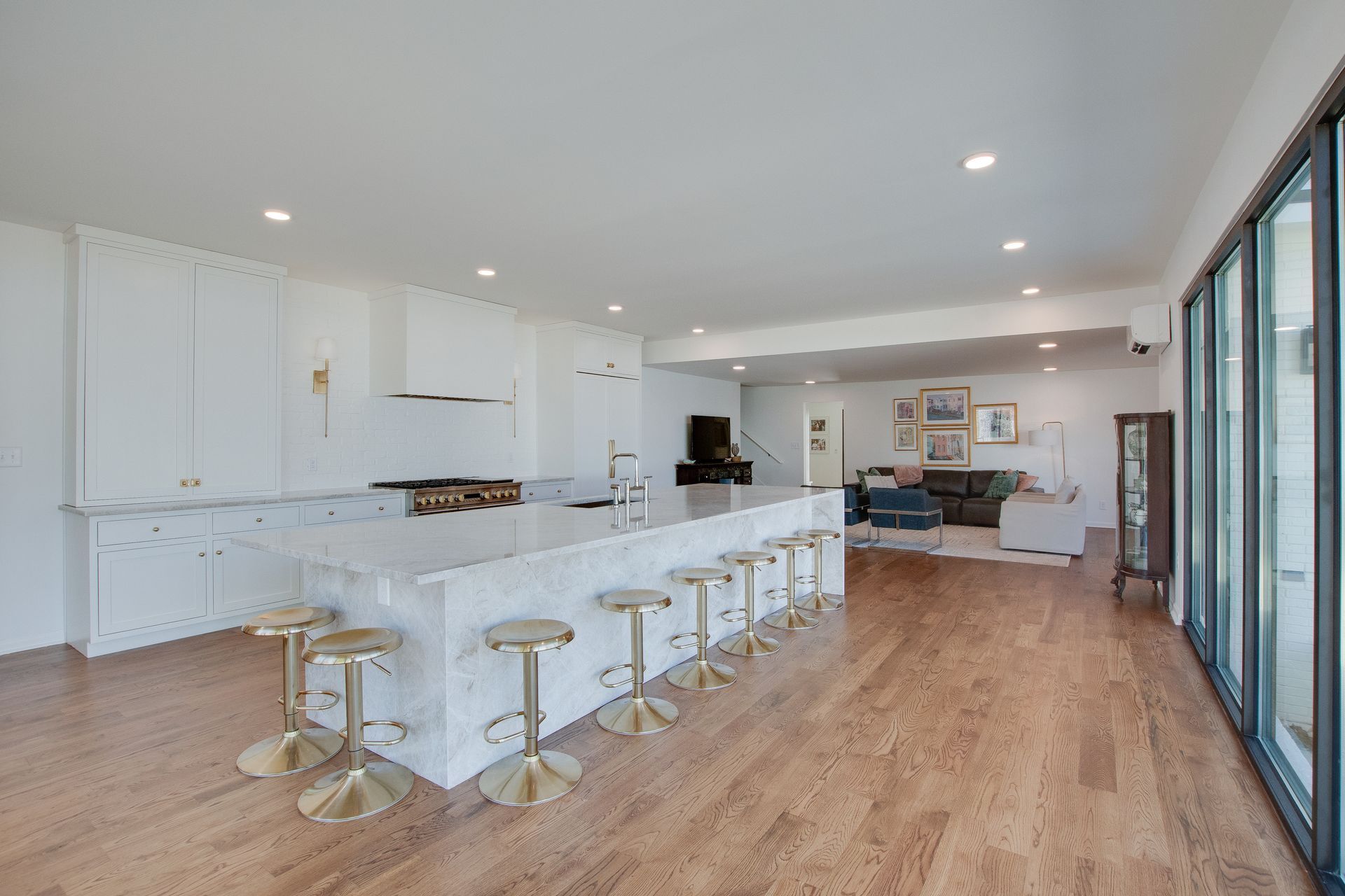A kitchen with a large island , stools and a piano.