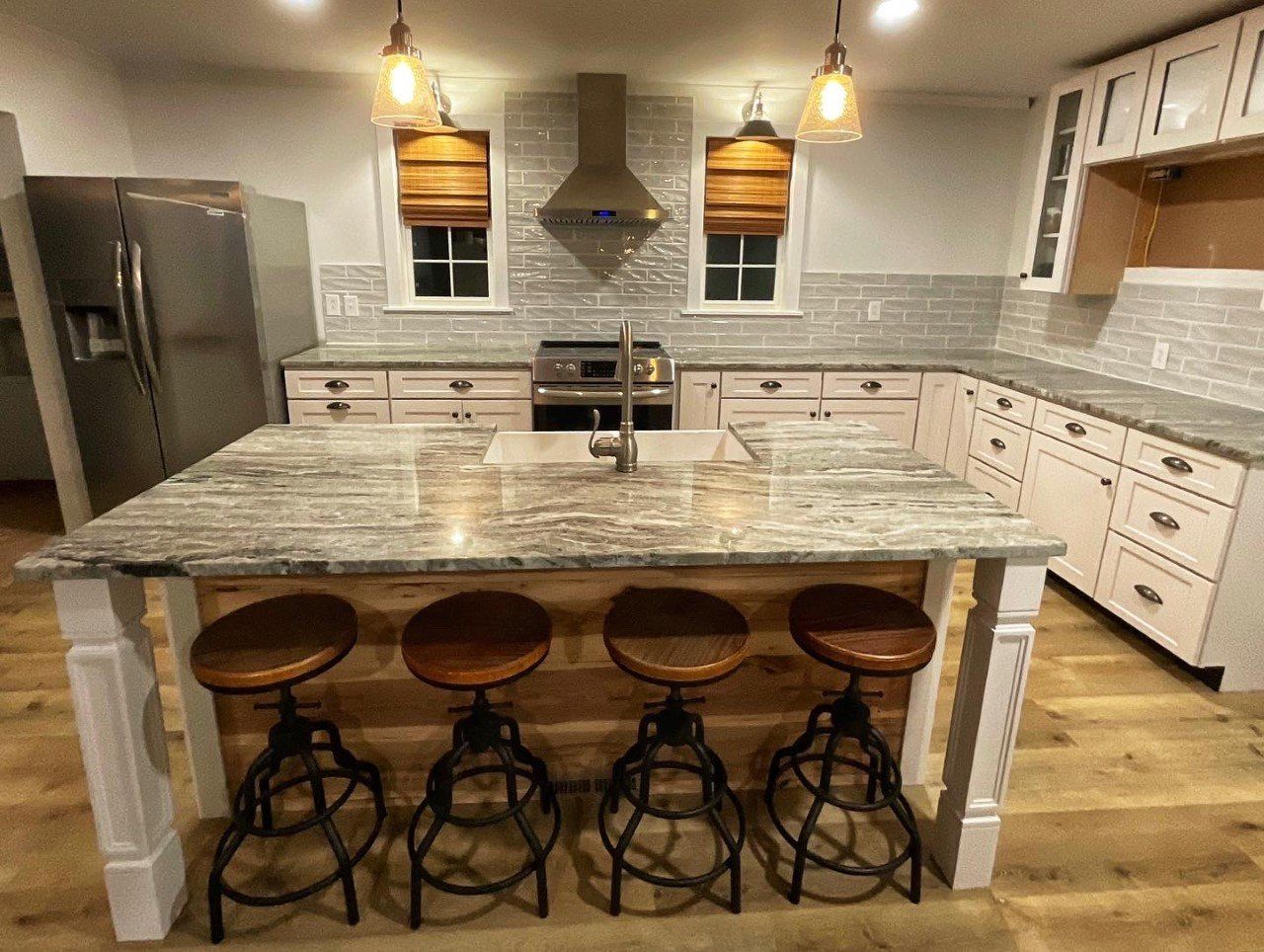 A kitchen with a large island and stools