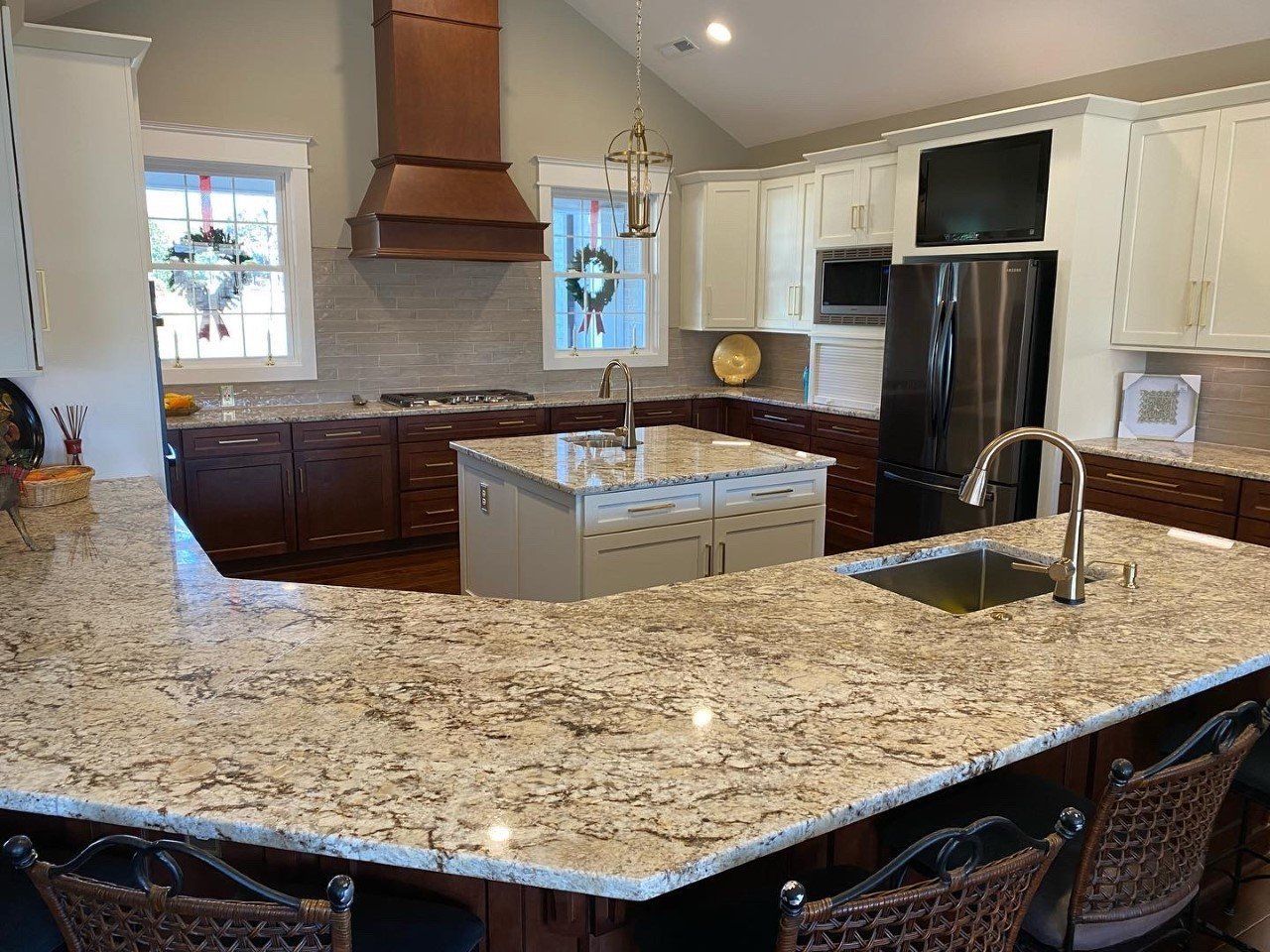 A kitchen with granite counter tops and stainless steel appliances.