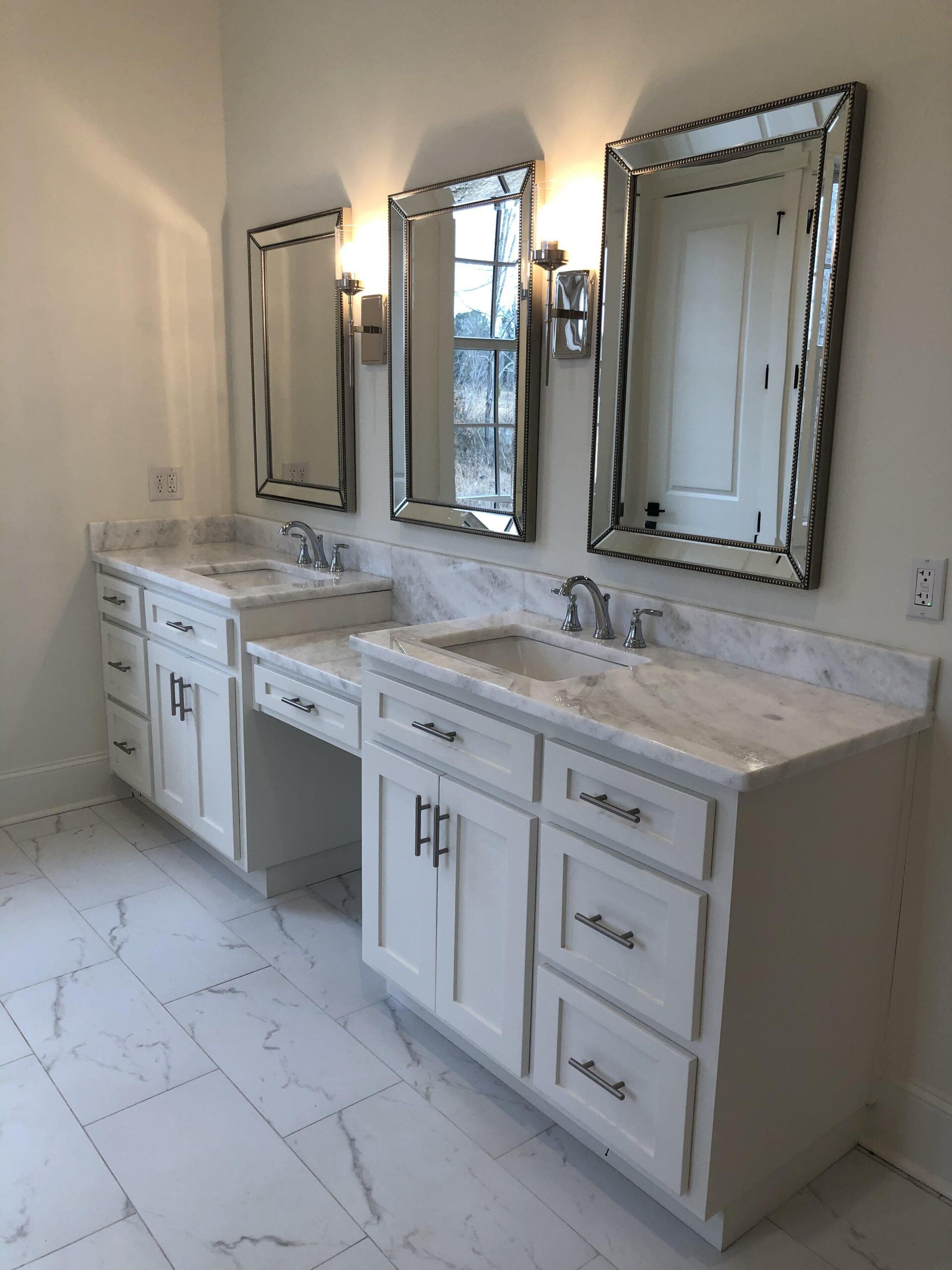 A bathroom with two sinks and two mirrors.