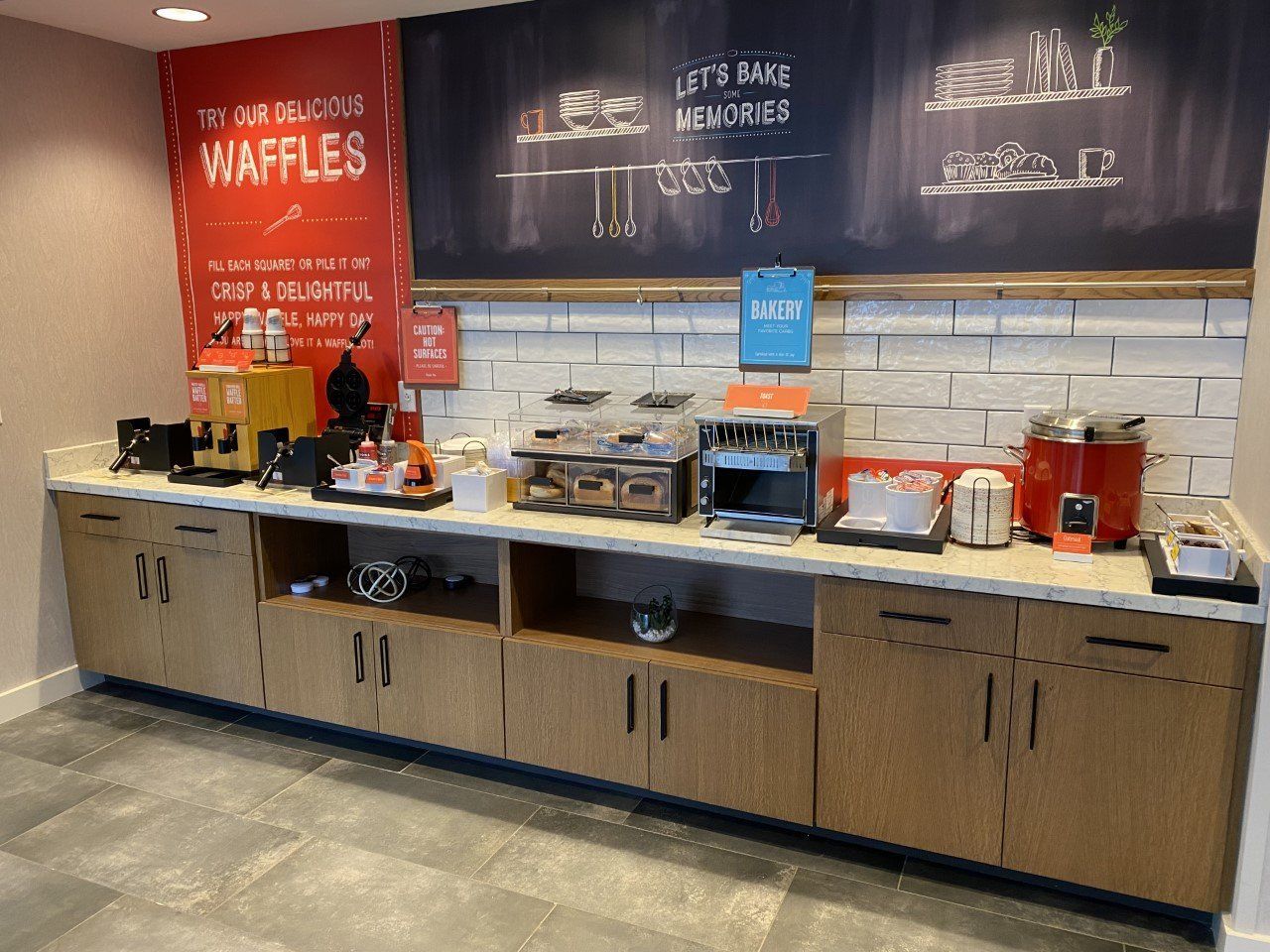 A kitchen with a chalkboard that says waffles on it