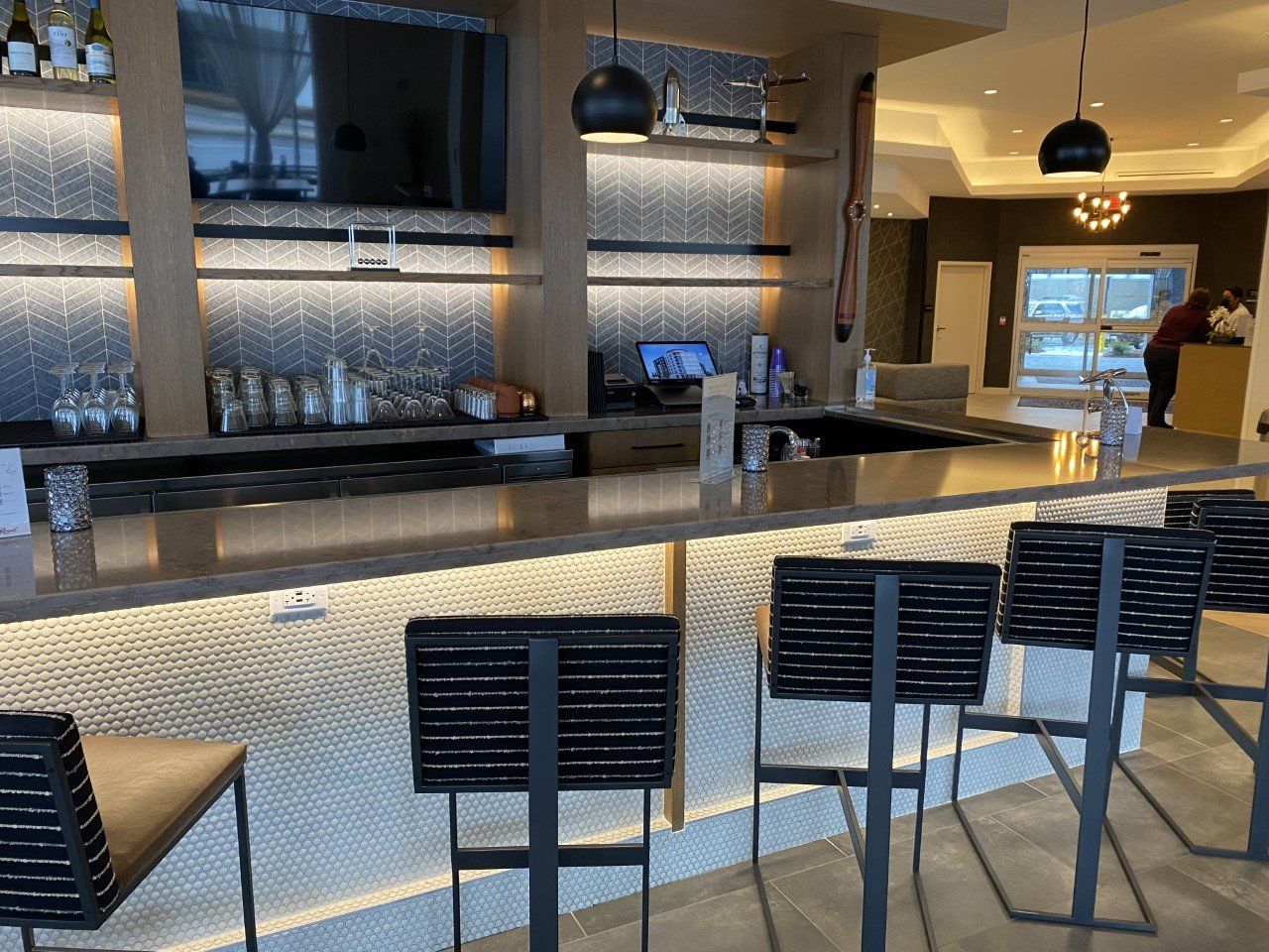 A bar with stools and a counter in a restaurant.