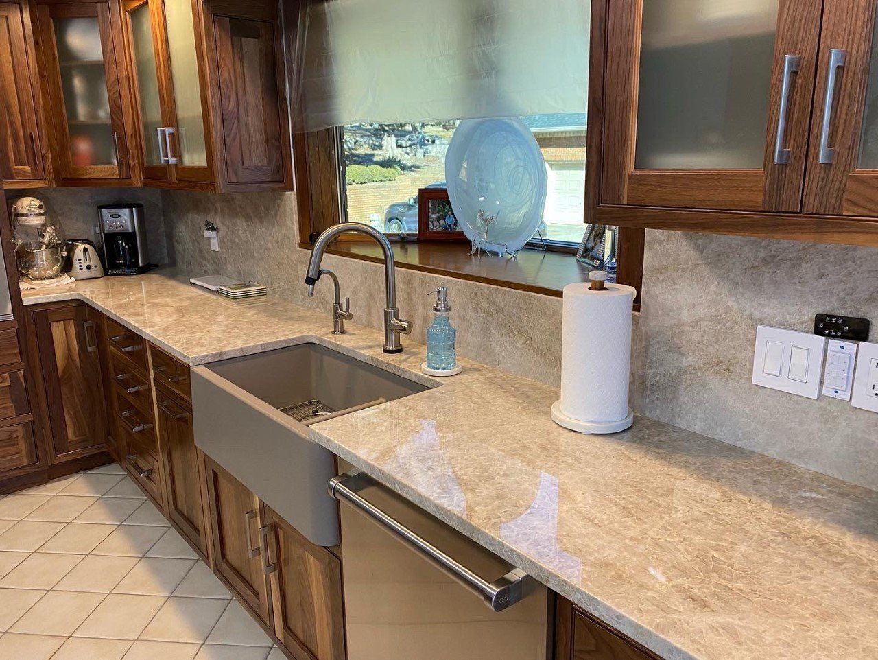 A kitchen with a sink and a paper towel holder on the counter.