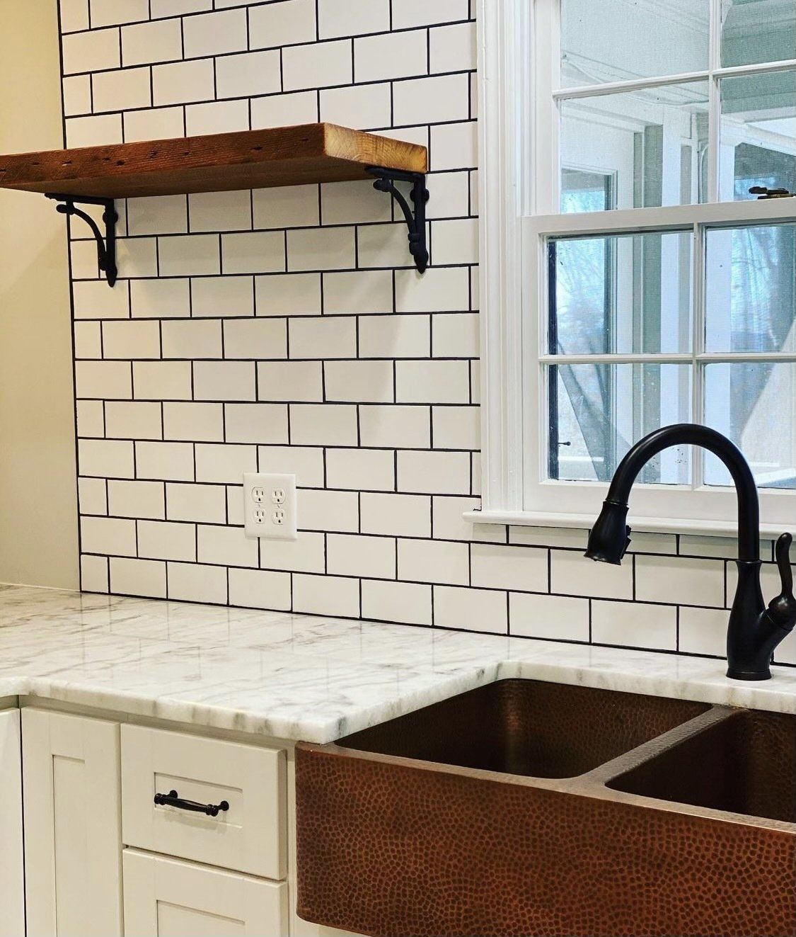 A kitchen with a sink and a window.