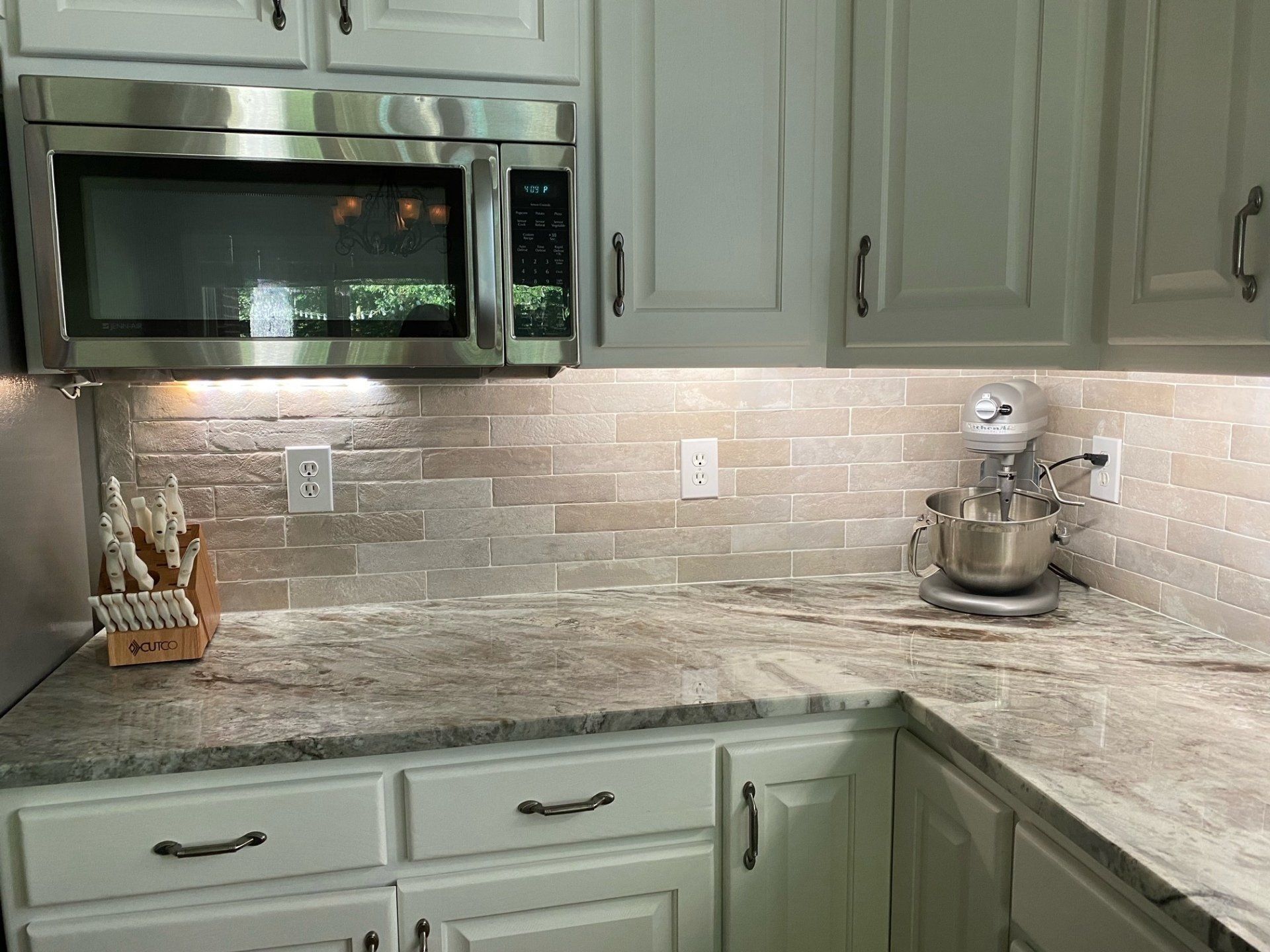 A kitchen with stainless steel appliances and granite counter tops