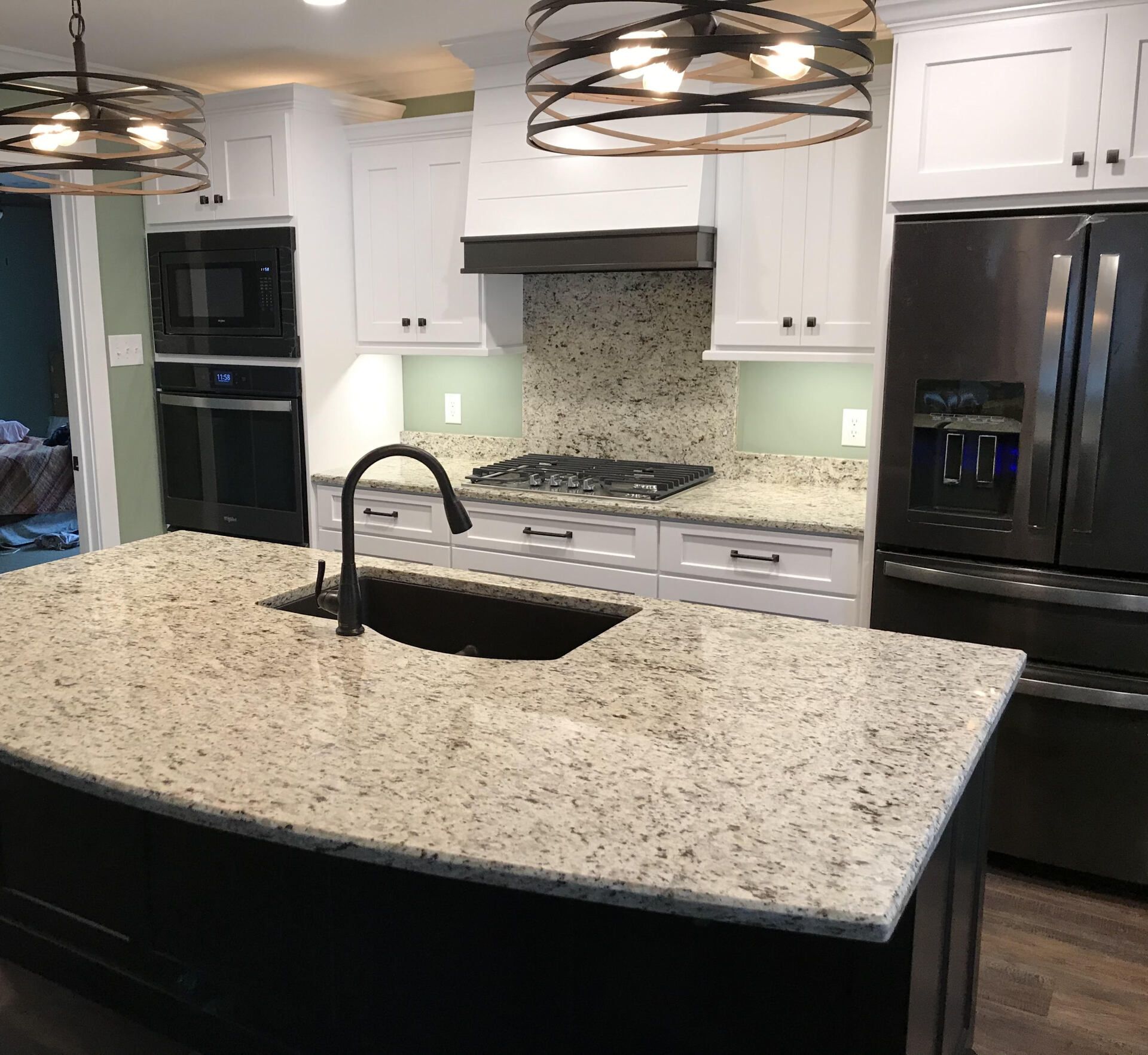 A kitchen with granite counter tops and stainless steel appliances