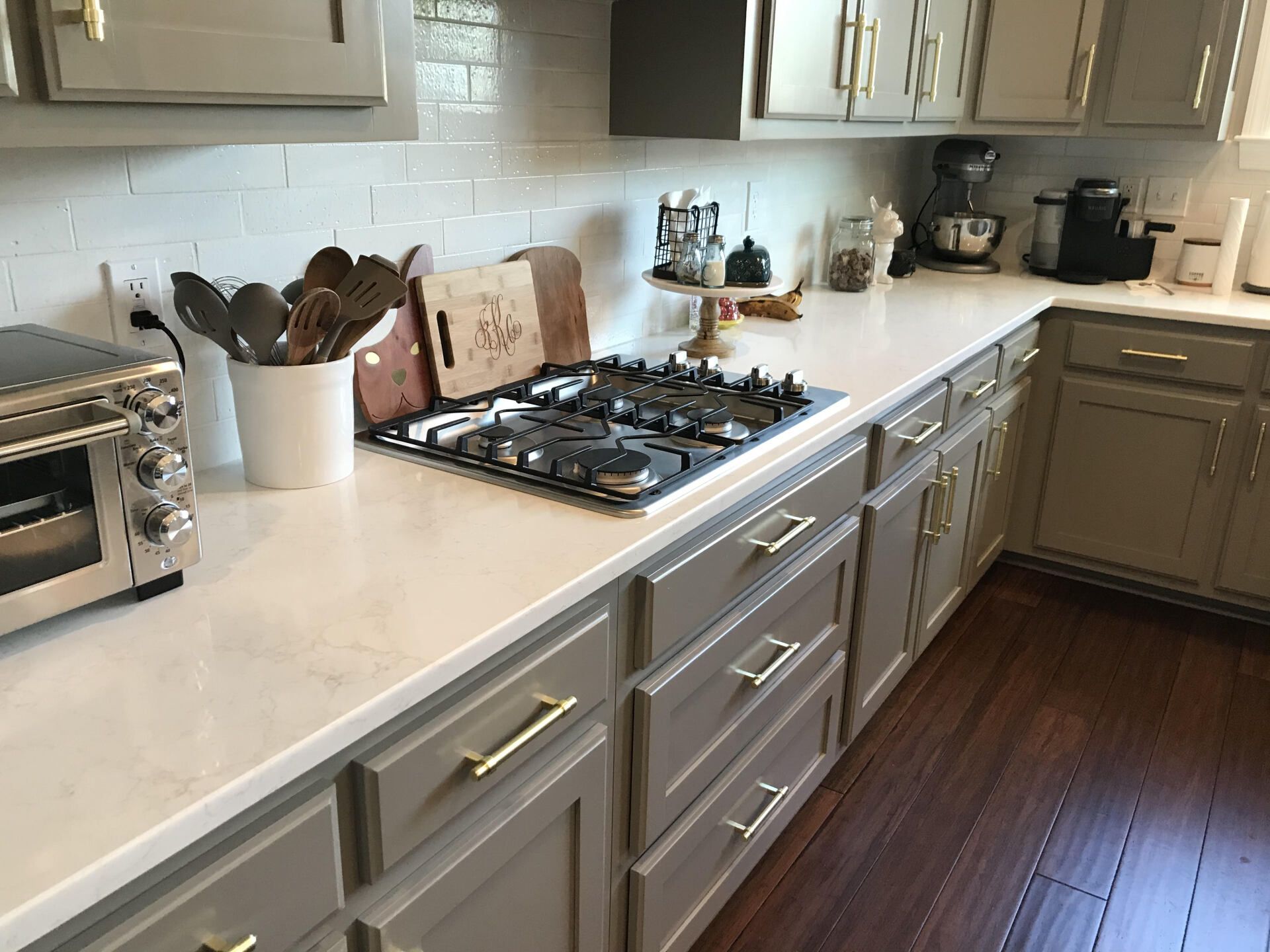 A kitchen with a stove top oven and a toaster oven