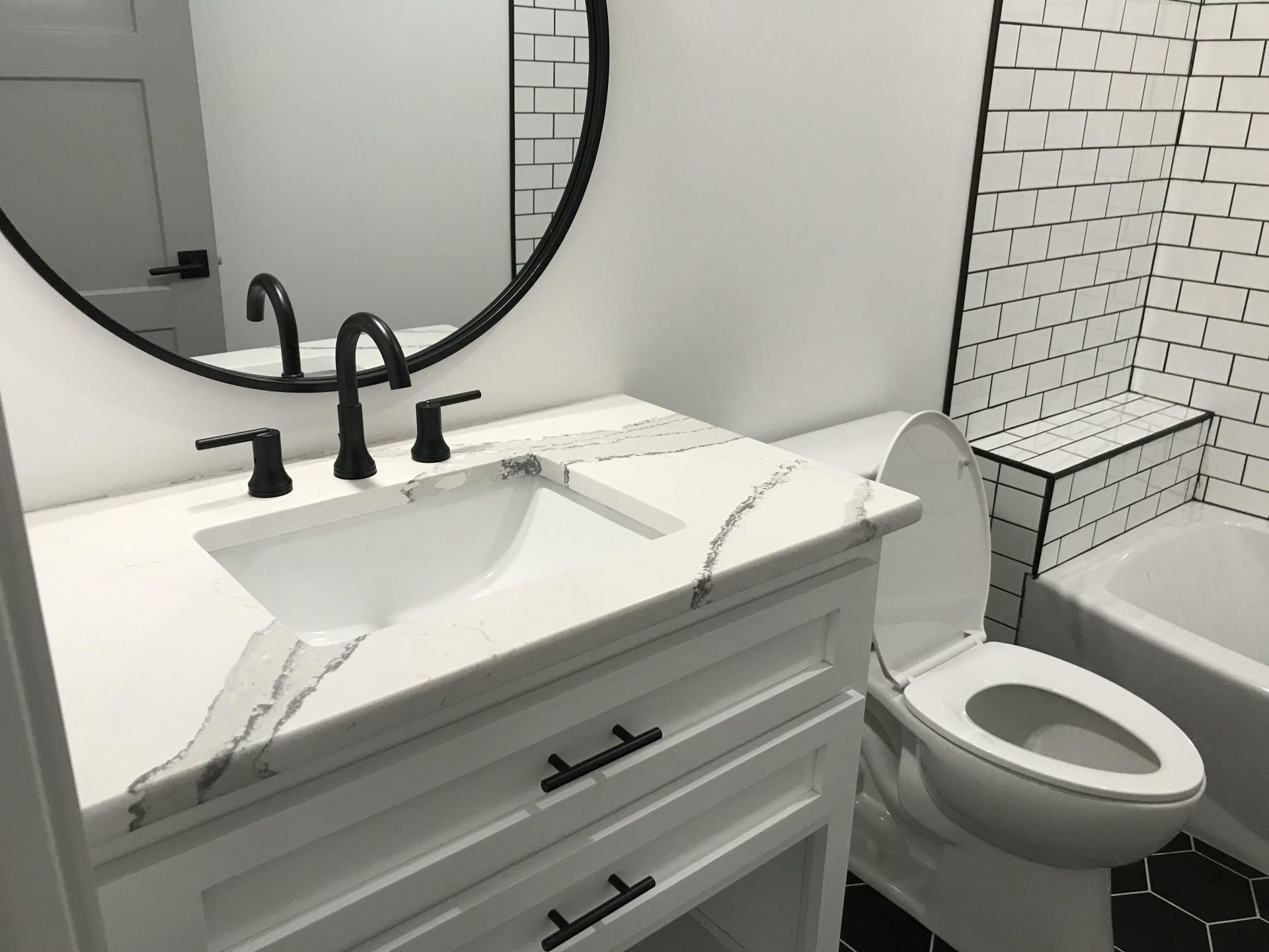 A bathroom with a sink , toilet , and mirror.