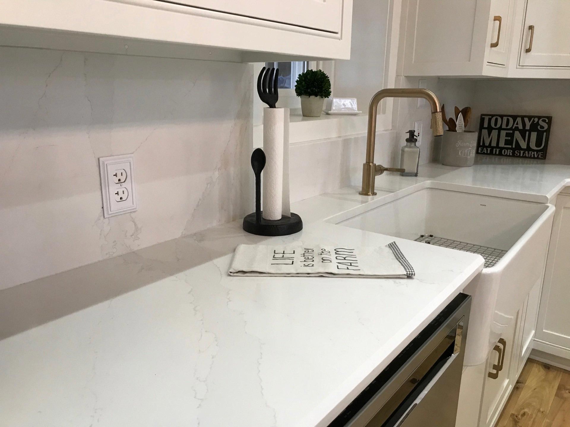 A kitchen with a sink and a sign that says today 's menu.