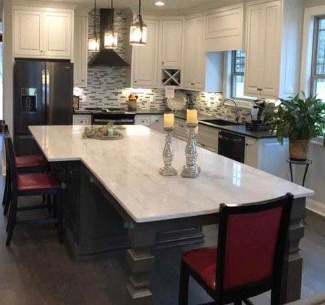 A kitchen with a large island and candles on it