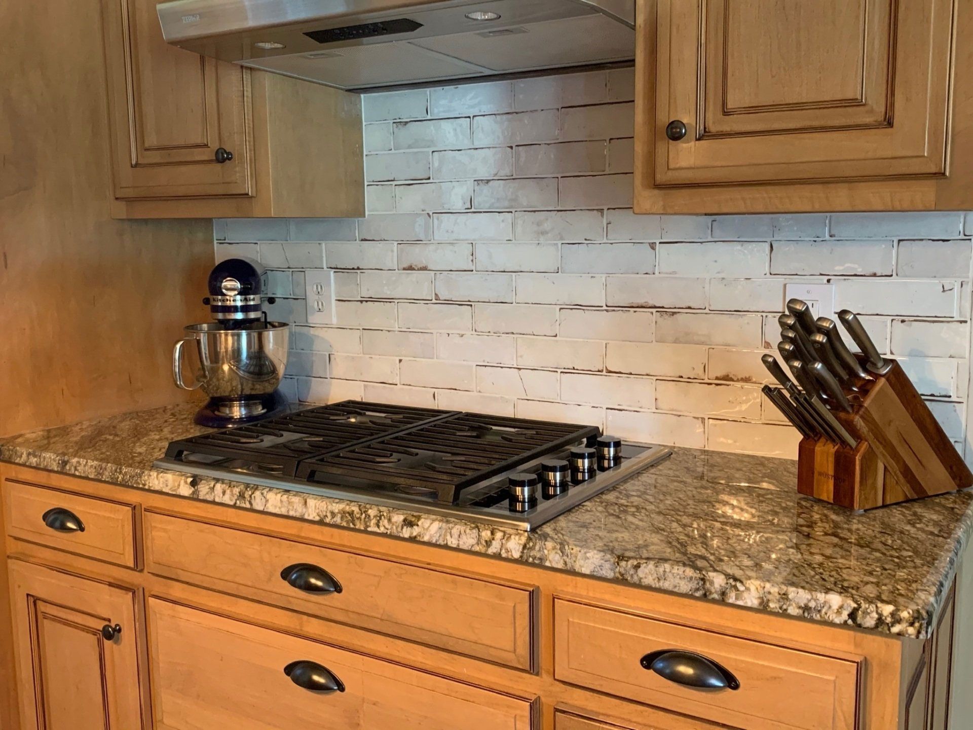 A kitchen with wooden cabinets and a stove top oven