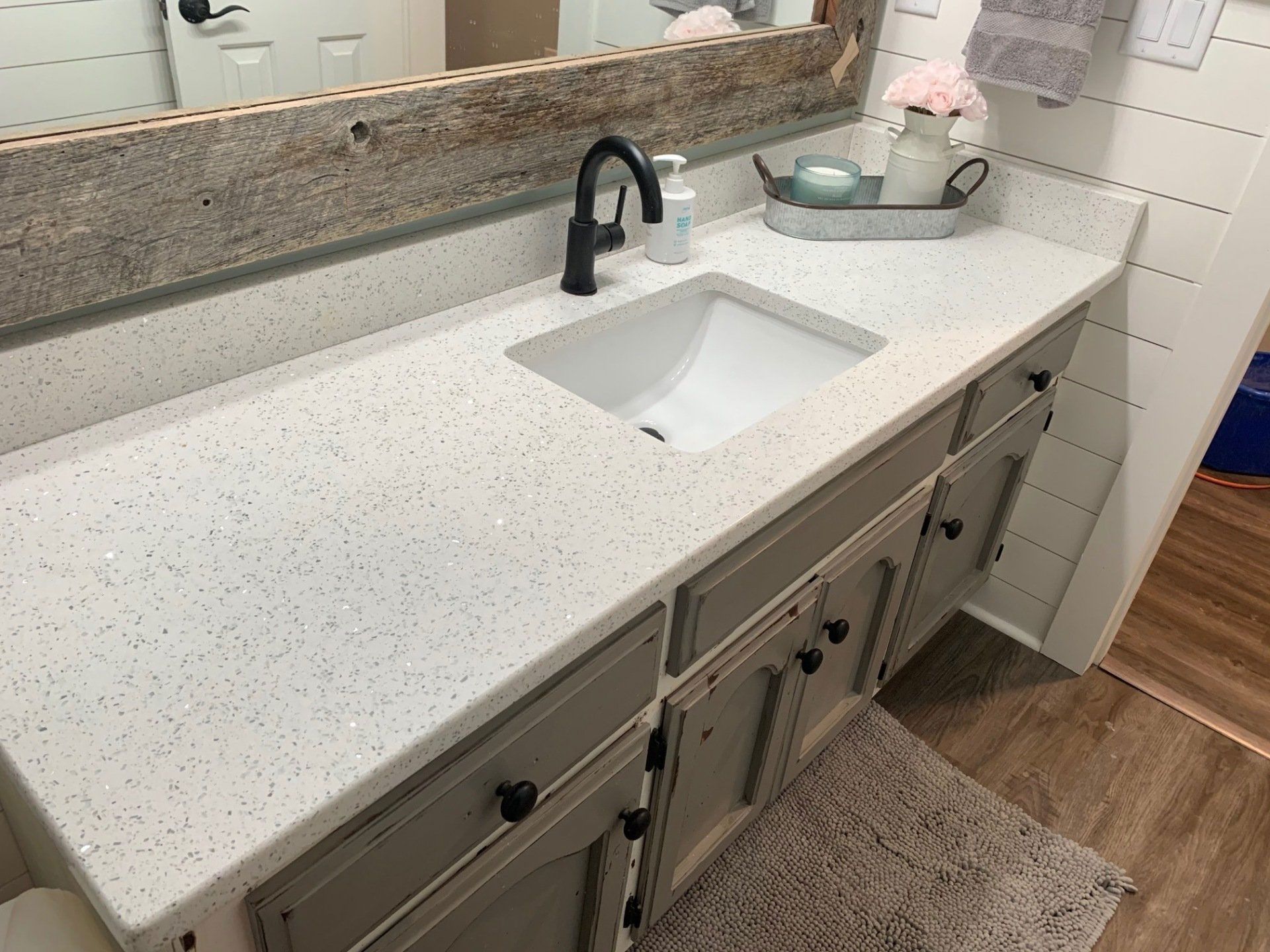 A bathroom vanity with a sink and a mirror.