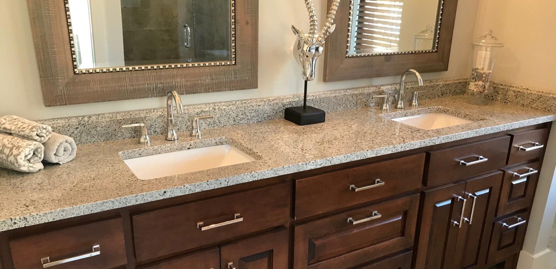 A bathroom with two sinks and two mirrors.