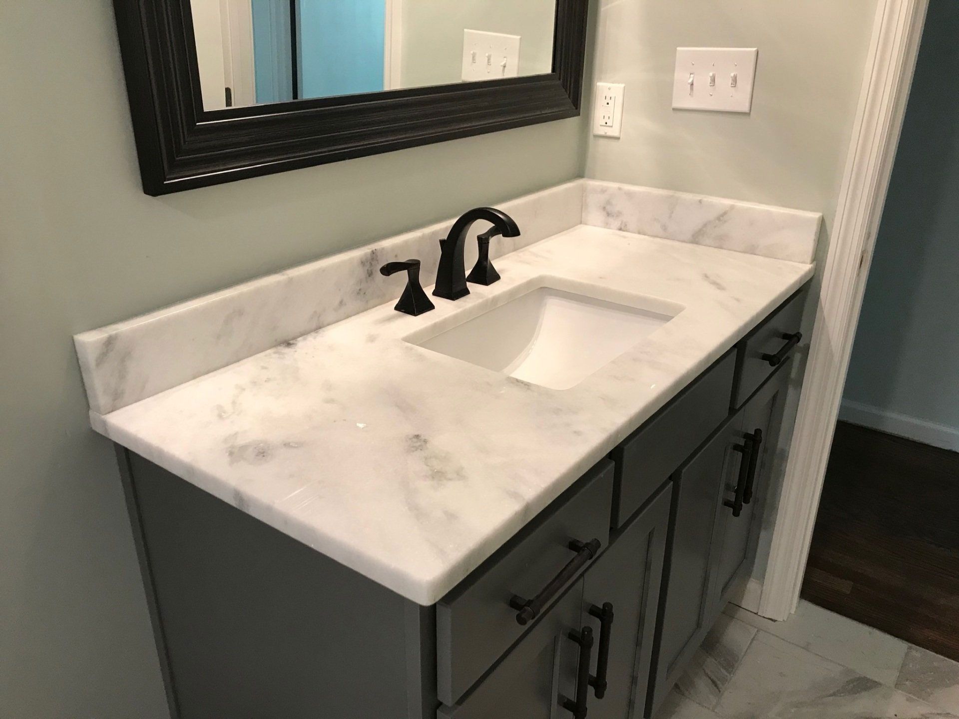A bathroom vanity with a sink and a mirror.