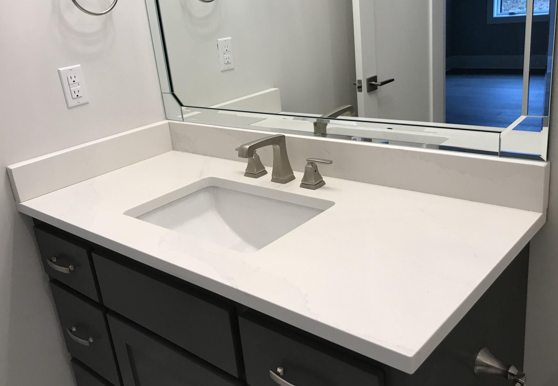 A bathroom vanity with a sink and a mirror.