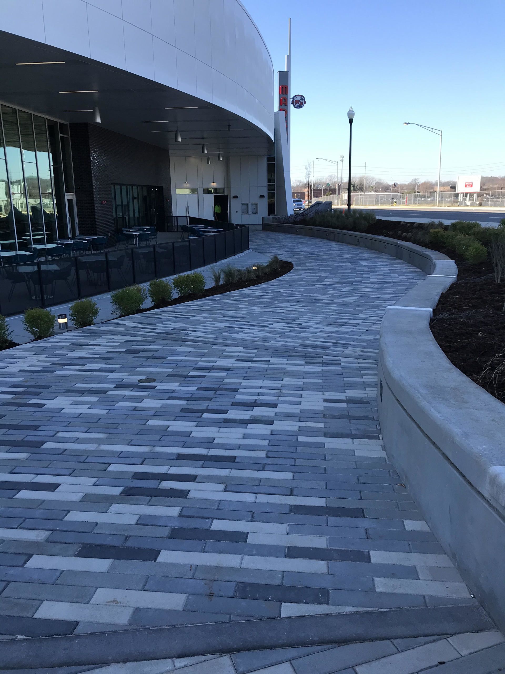 A brick walkway in front of a building