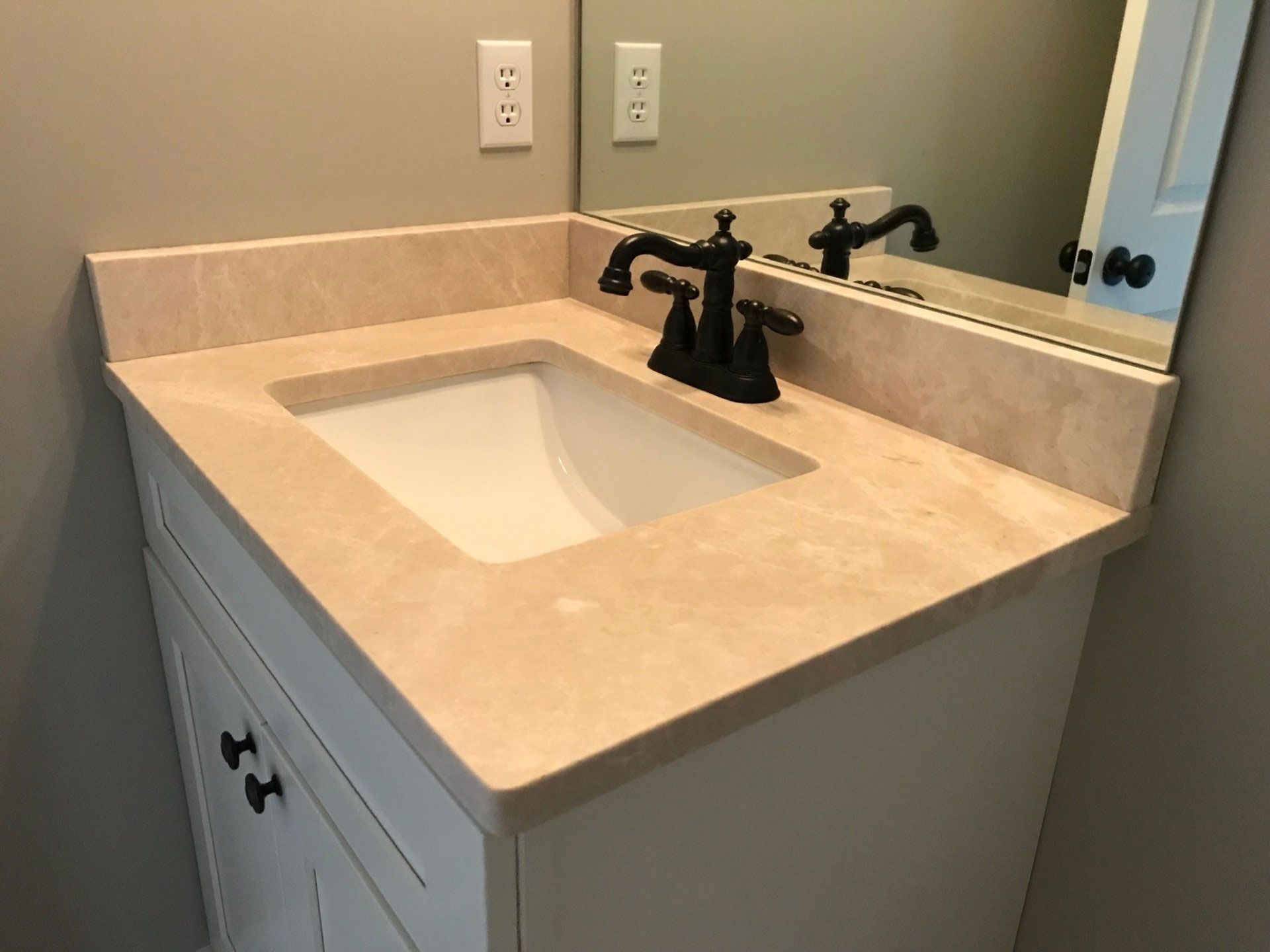 A bathroom vanity with a sink and a mirror