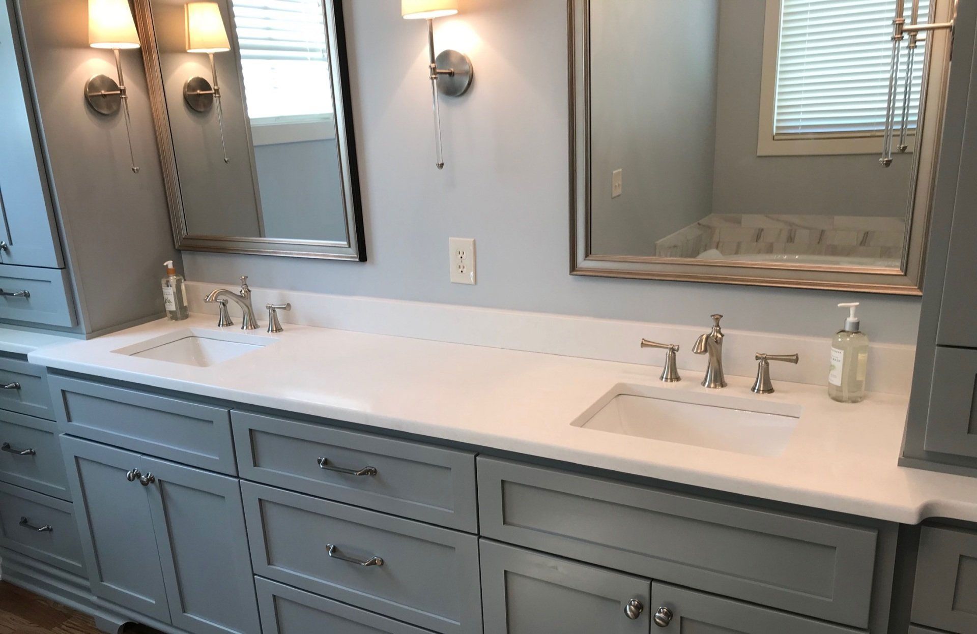 A bathroom with two sinks and two mirrors.