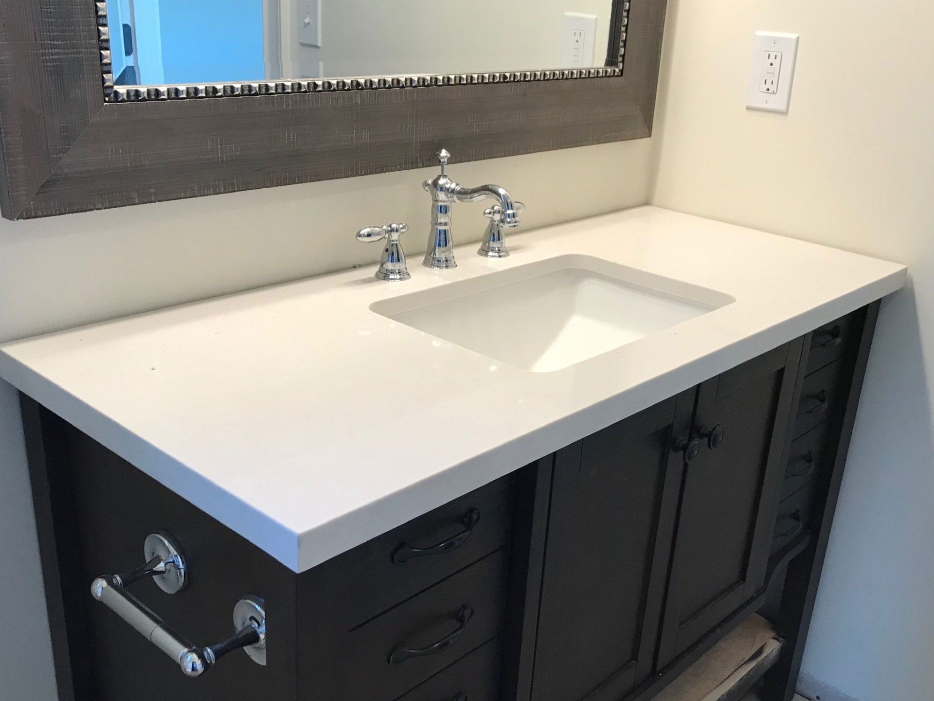 A bathroom vanity with a sink and a mirror