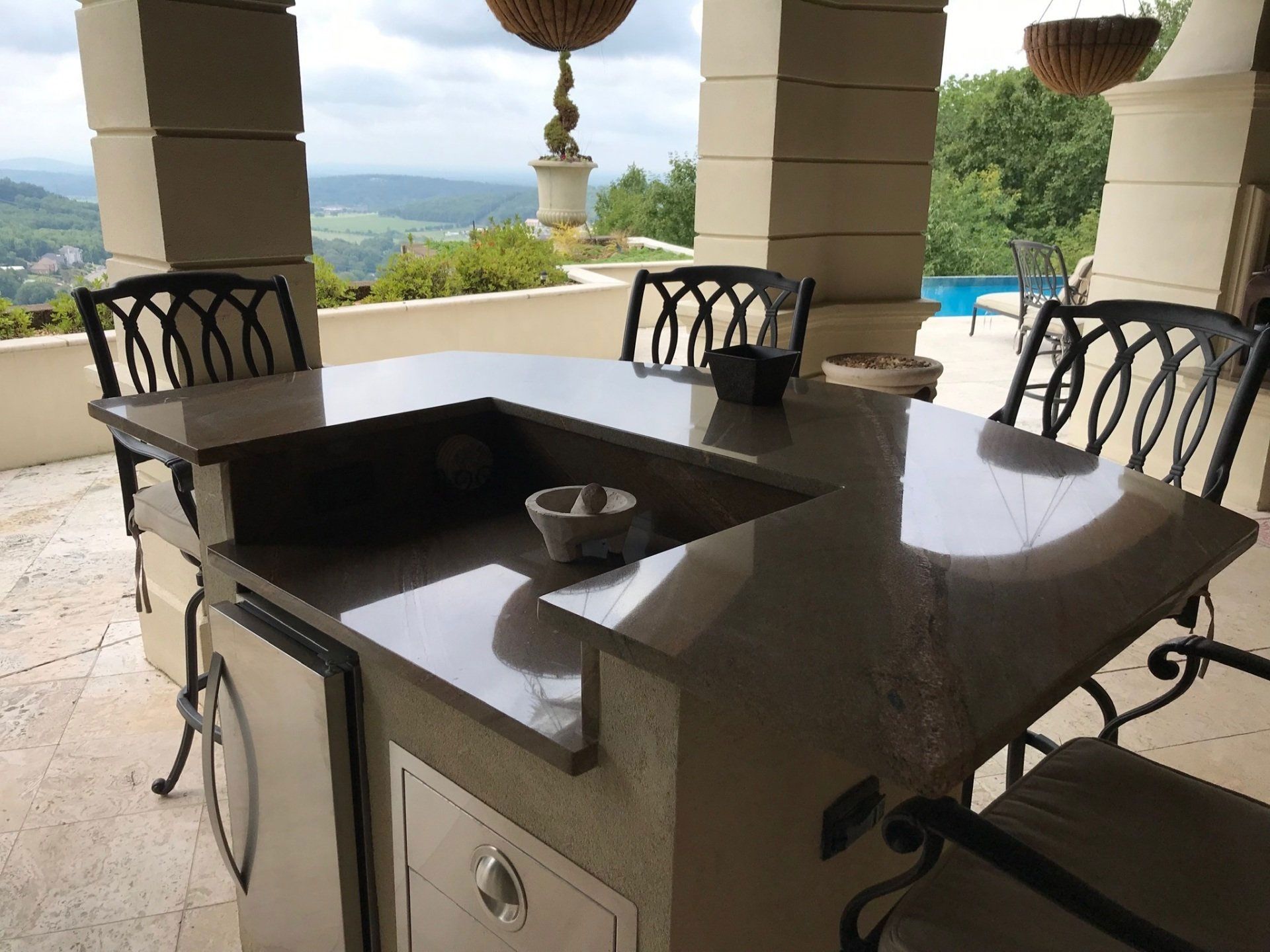 A patio with a table and chairs and a sink