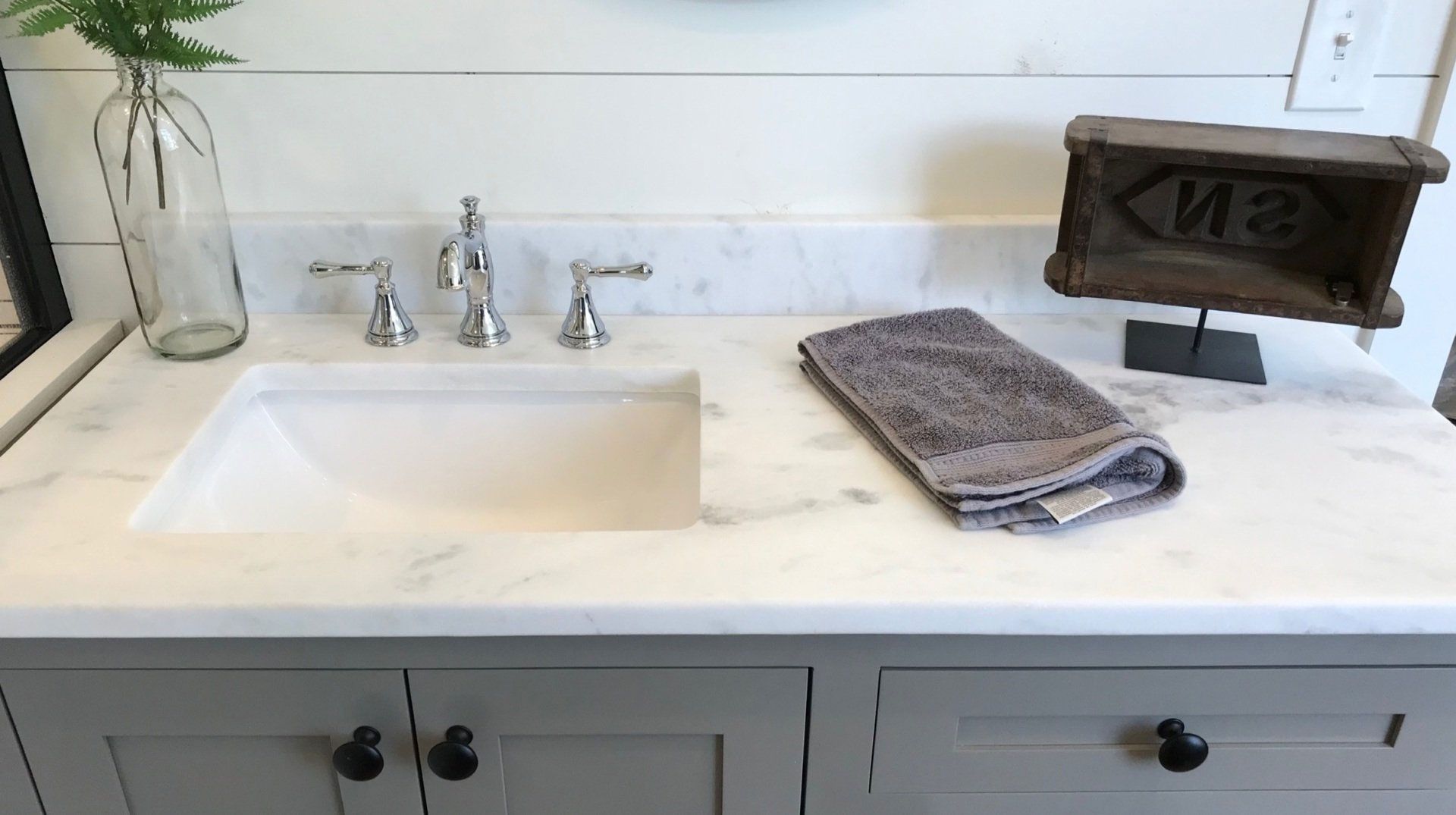 A bathroom vanity with a sink and a towel on it.
