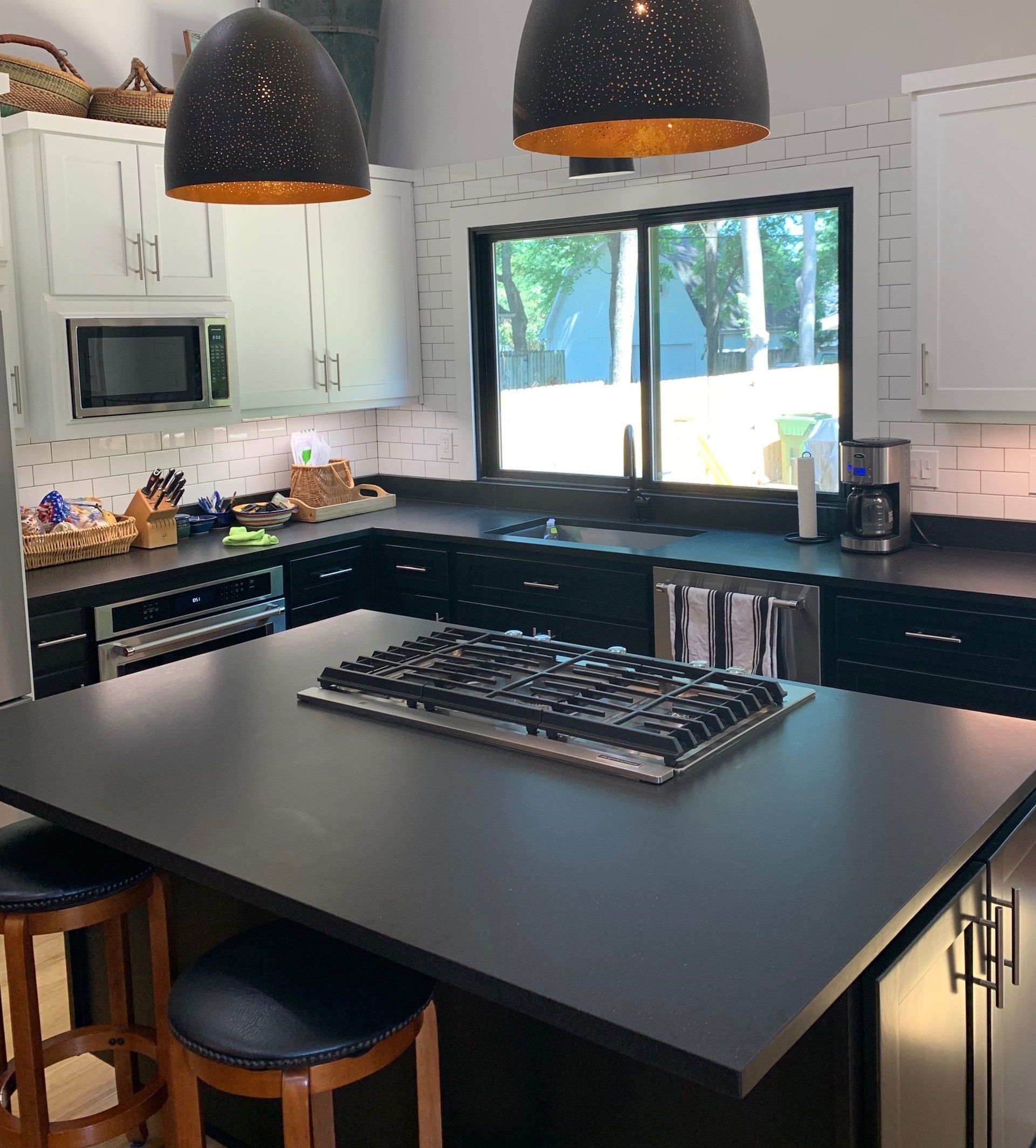 A kitchen with a large island and a stove top oven