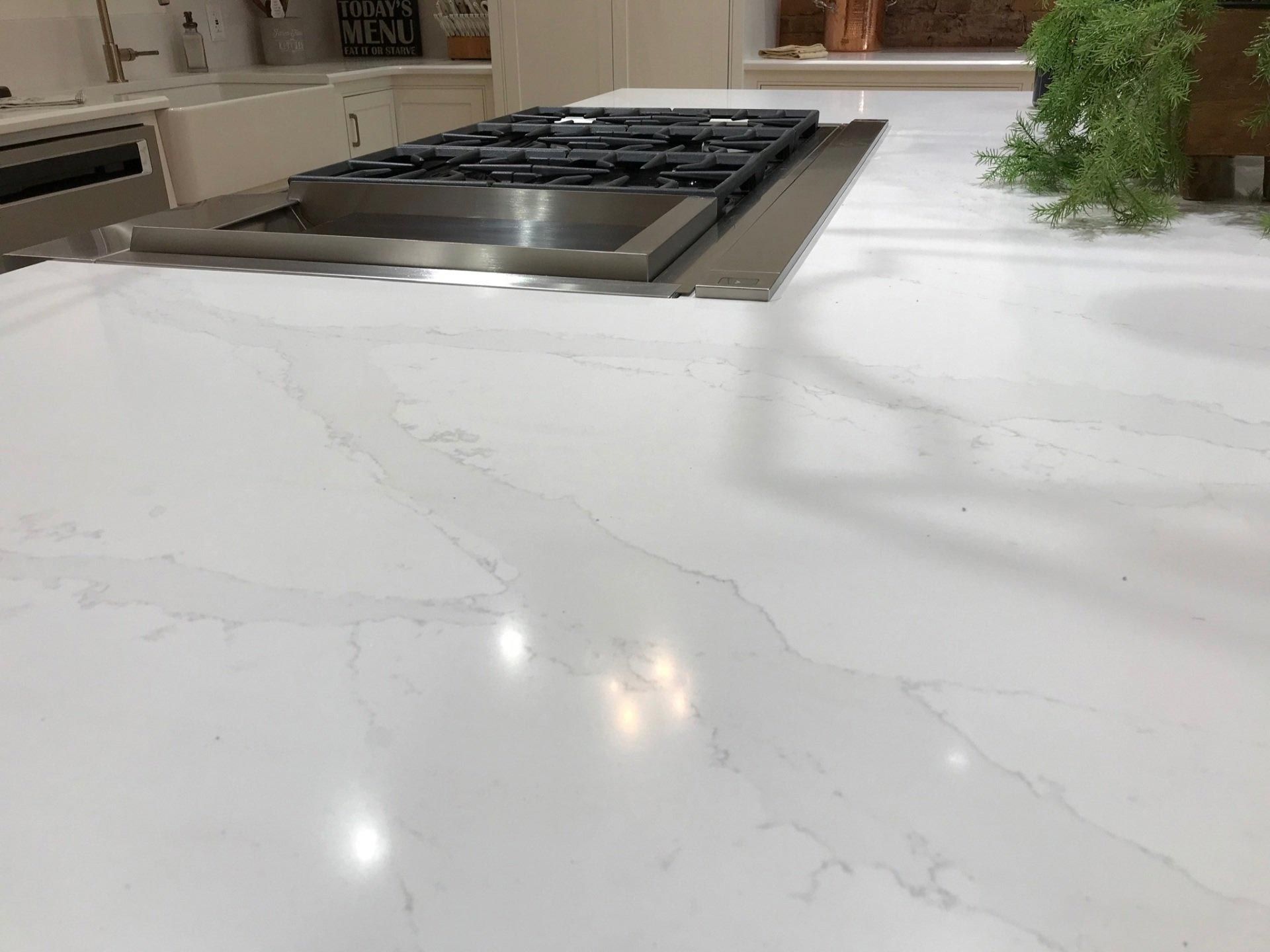 A stove top oven is sitting on top of a white counter in a kitchen.