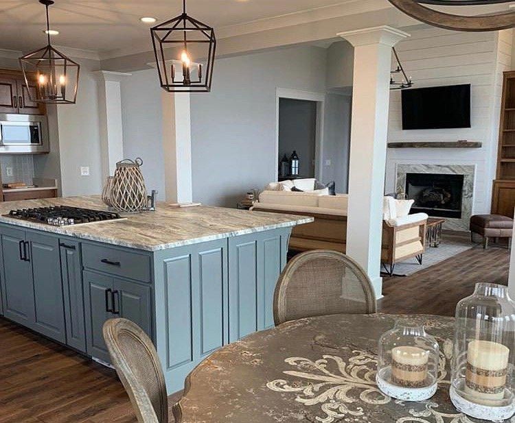 A kitchen with a large island and a table with candles on it.