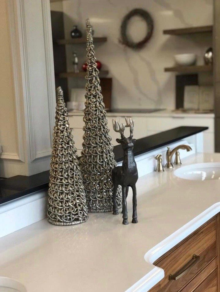 A bathroom counter with a reindeer and christmas trees on it.