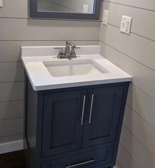A bathroom vanity with a sink and a mirror