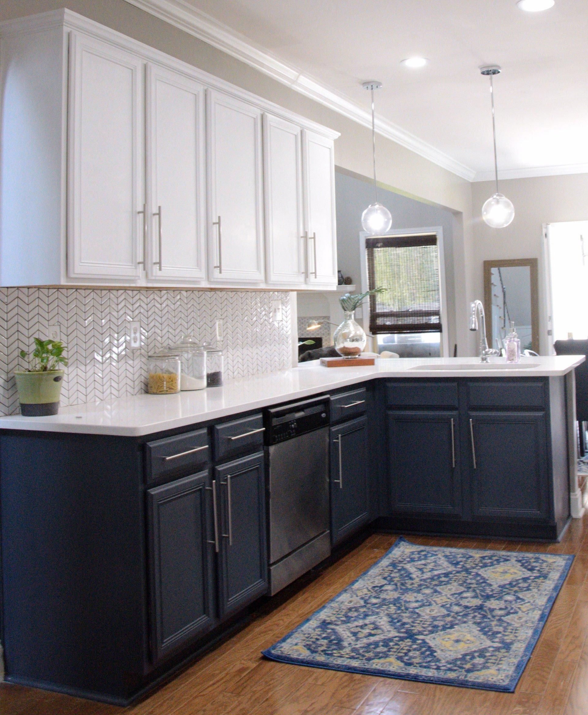 A kitchen with black cabinets and white counter tops
