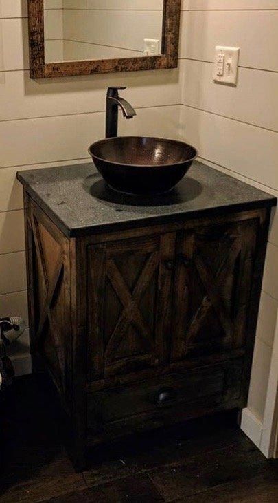 A bathroom vanity with a sink and a mirror.