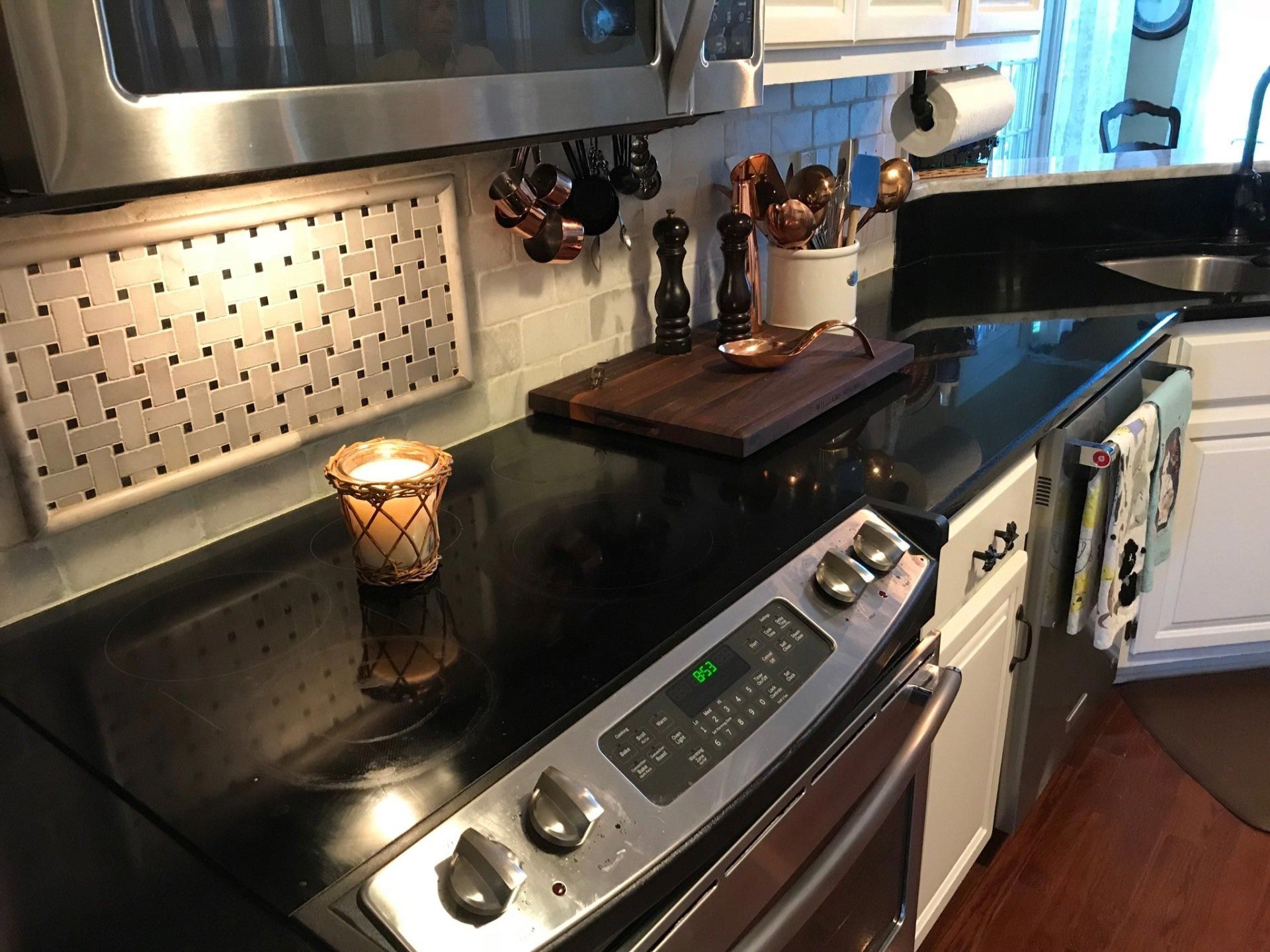 A kitchen with a stove top oven and a microwave