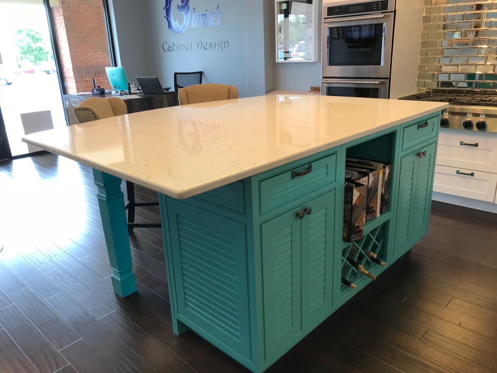 A blue kitchen island with a white counter top