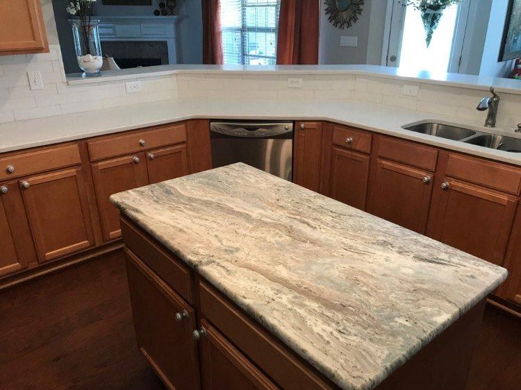 A kitchen with a large island in the middle of it.