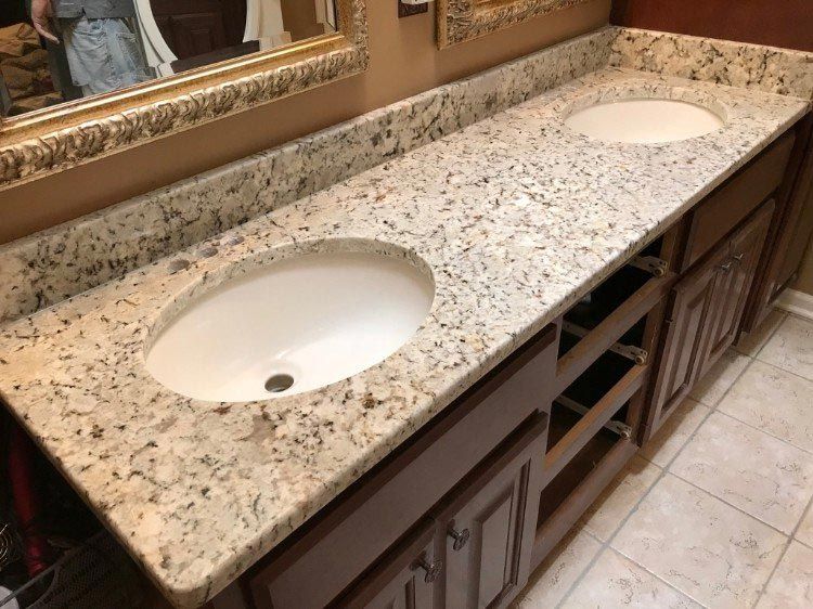 A bathroom with two sinks and a mirror.