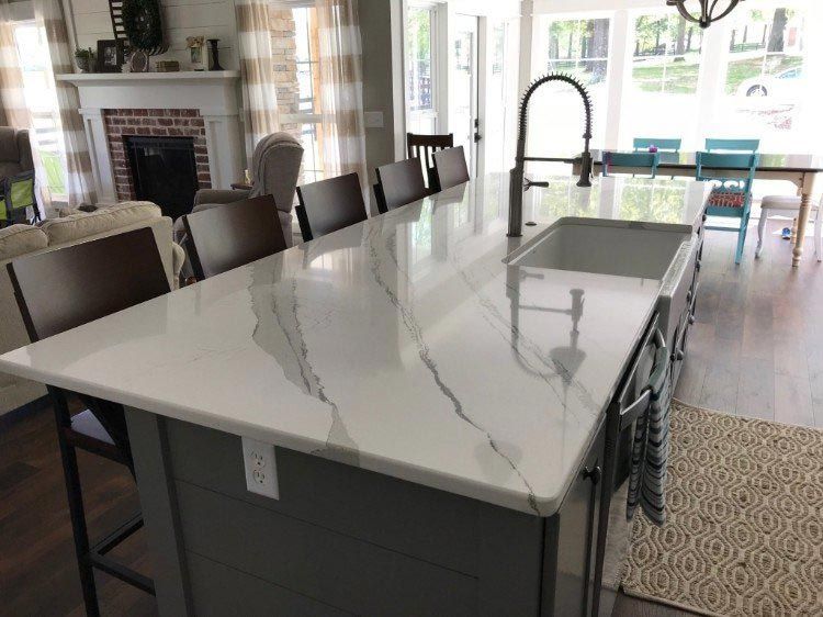 A kitchen with a large island and a sink.