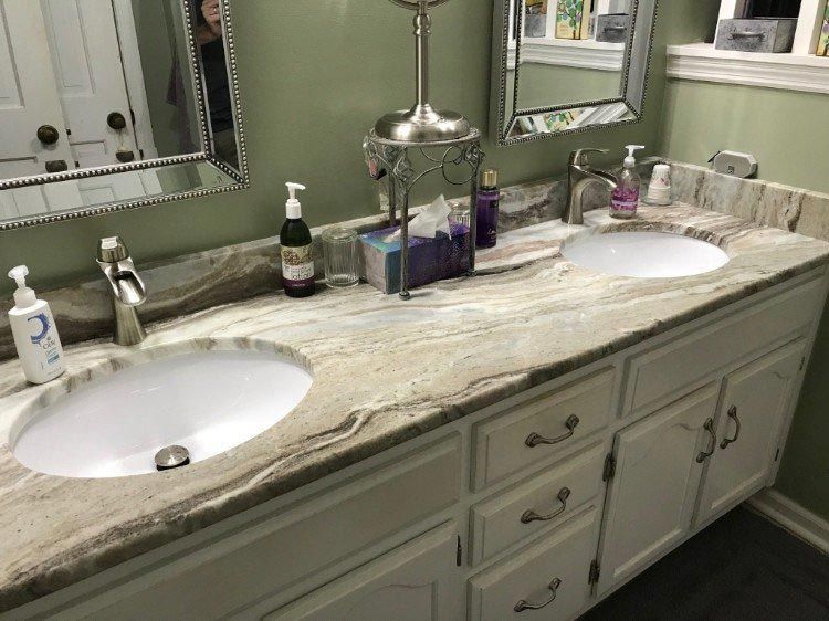 A bathroom with two sinks and a mirror.