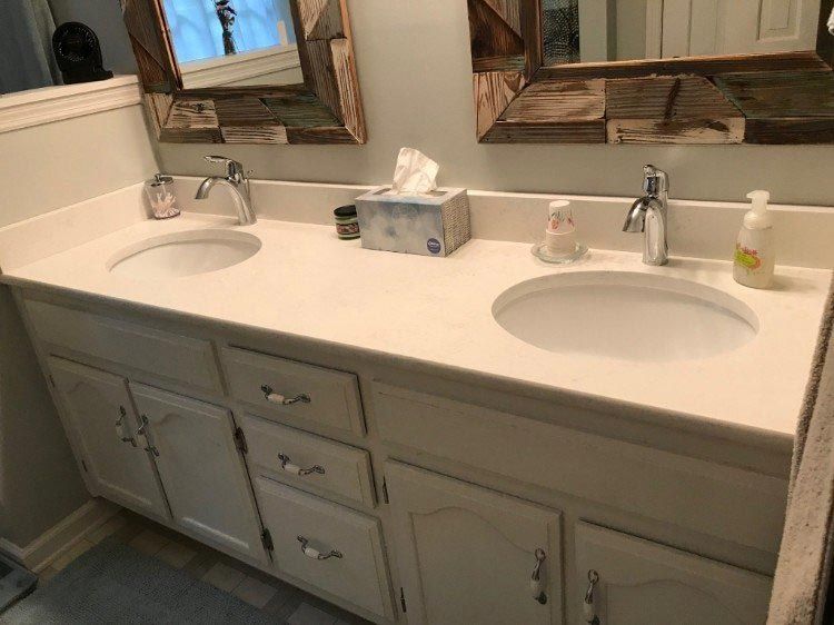 A bathroom with two sinks and two mirrors.