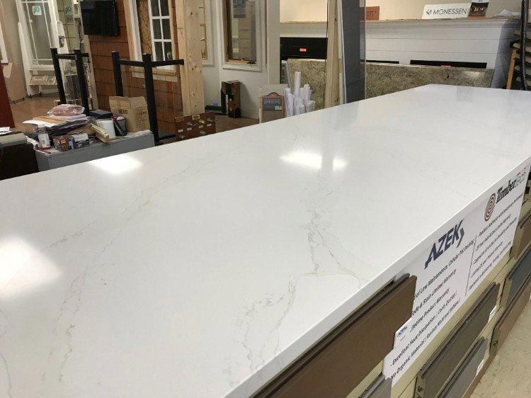 A long white counter top is sitting in a room.