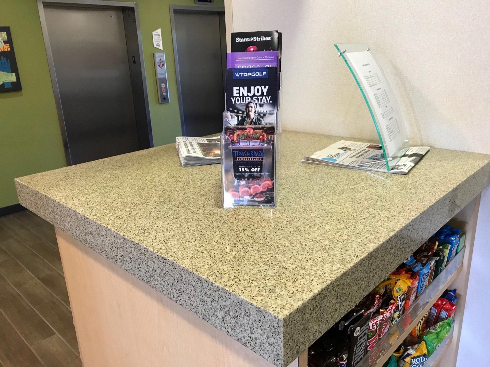 A table with a brochure on it that says enjoy