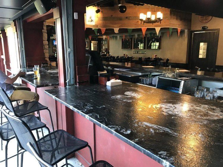 A man is sitting at a bar in a restaurant