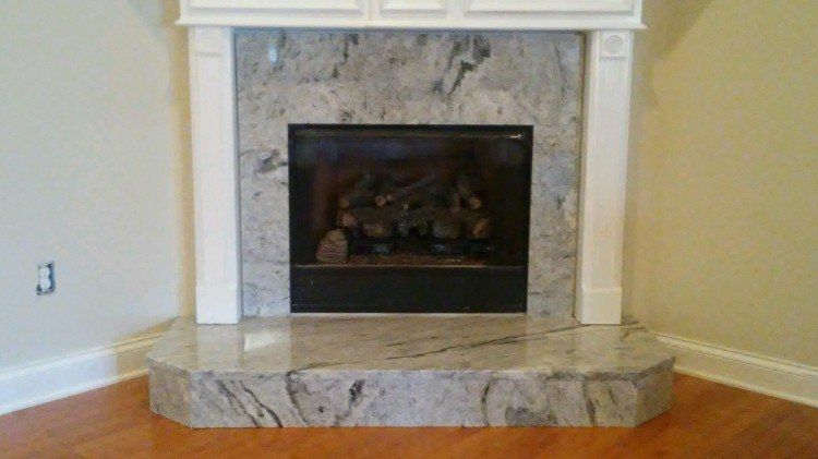 There is a fireplace in the corner of the room.