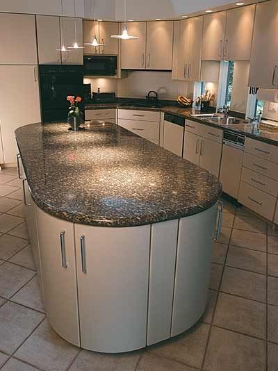 A kitchen with a large island in the middle of it