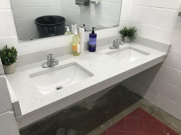 A bathroom with two sinks and a mirror.