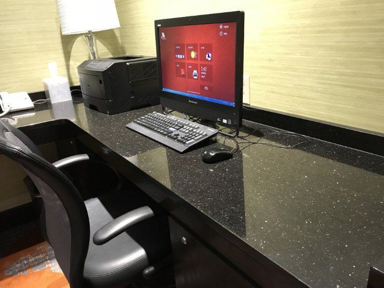A desk with a computer and a printer on it