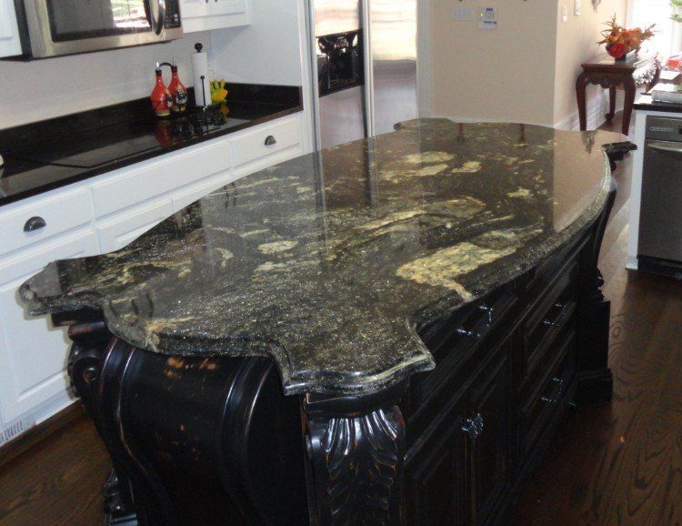 A kitchen with a large granite counter top