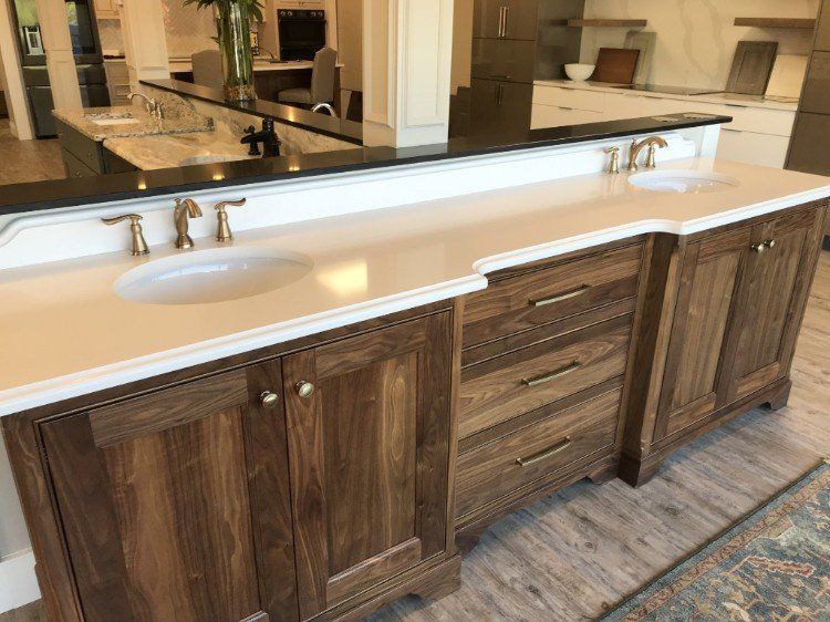 A bathroom vanity with two sinks and a large mirror.