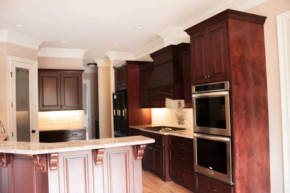 A kitchen with wooden cabinets and stainless steel appliances