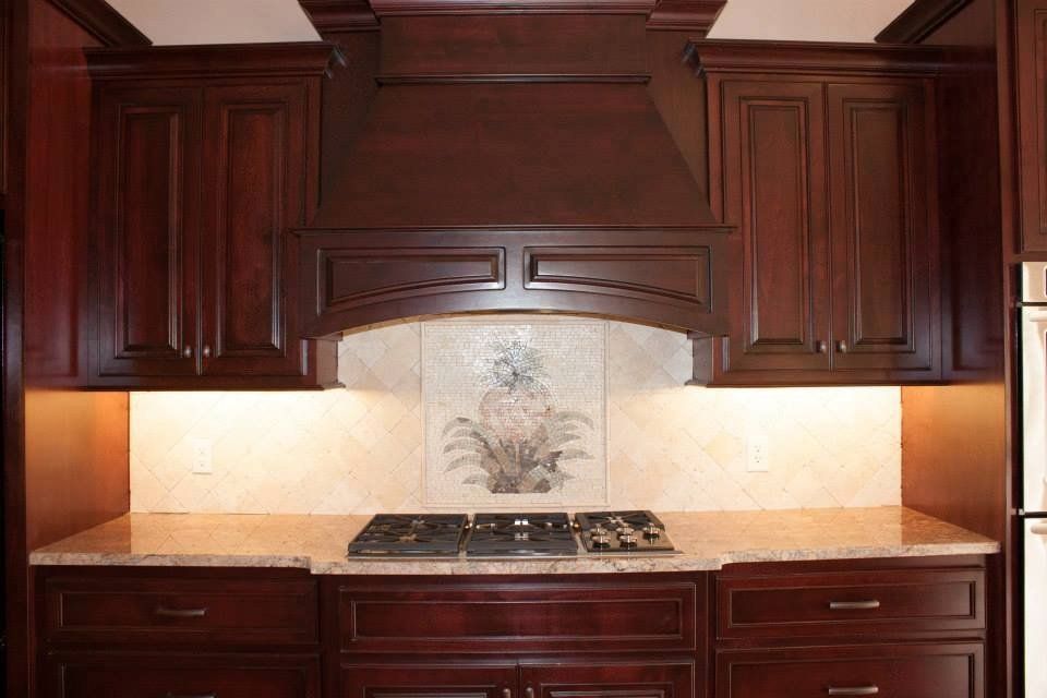 A kitchen with wooden cabinets and a stove top oven